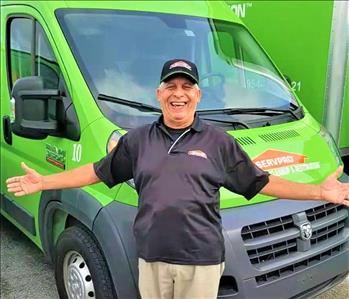 Roberto in front of a SERVPRO truck