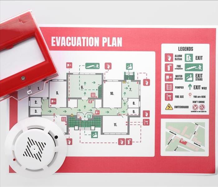 Evacuation plan, smoke detector and manual call point on white background
